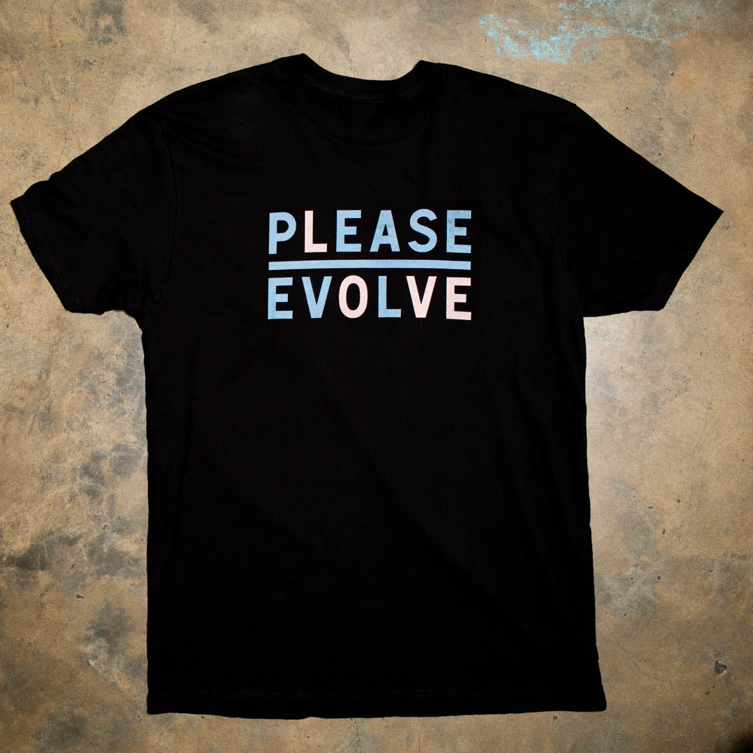 Please Evolve but with a twist. Please Love is a new version of our logo.  Light Blue with Pale ink print. 100% Black Cotton t shirt.  Stylish colorways. Look for the limited edition colorways to benefit nonprofits.